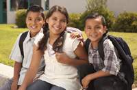 Young children smiling with backpacks