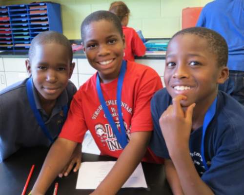 Three young boys smiling